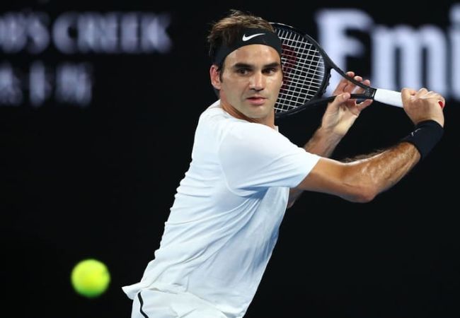 Người chơi sử dụng gậy tennis để thực hiện cú forehand mạnh mẽ